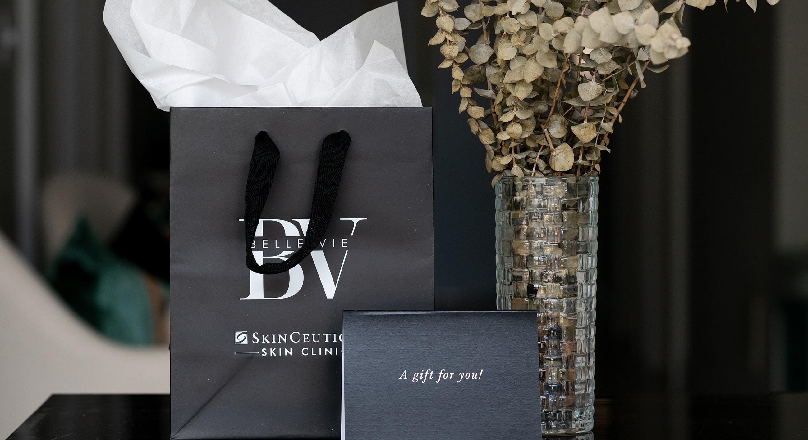 Two women holding Restylane products, smiling.