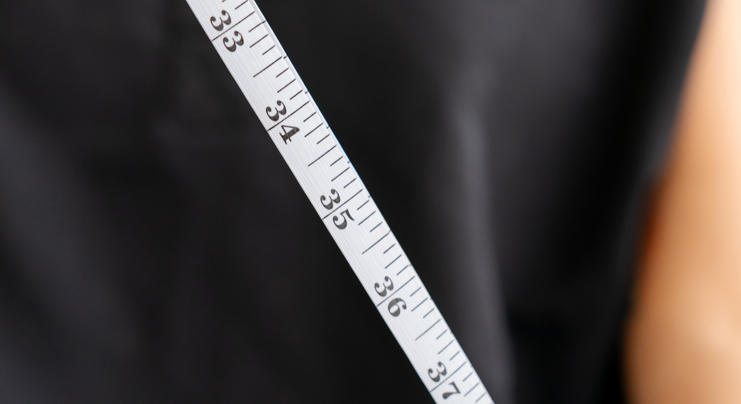 Measuring tape displayed against a dark background.